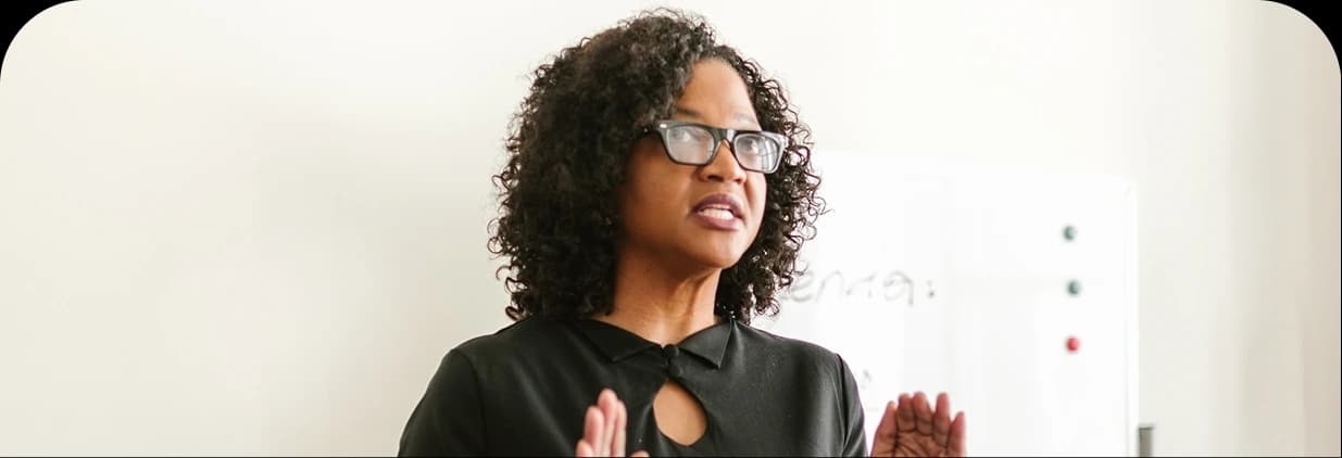 Woman presenting in front of a whiteboard