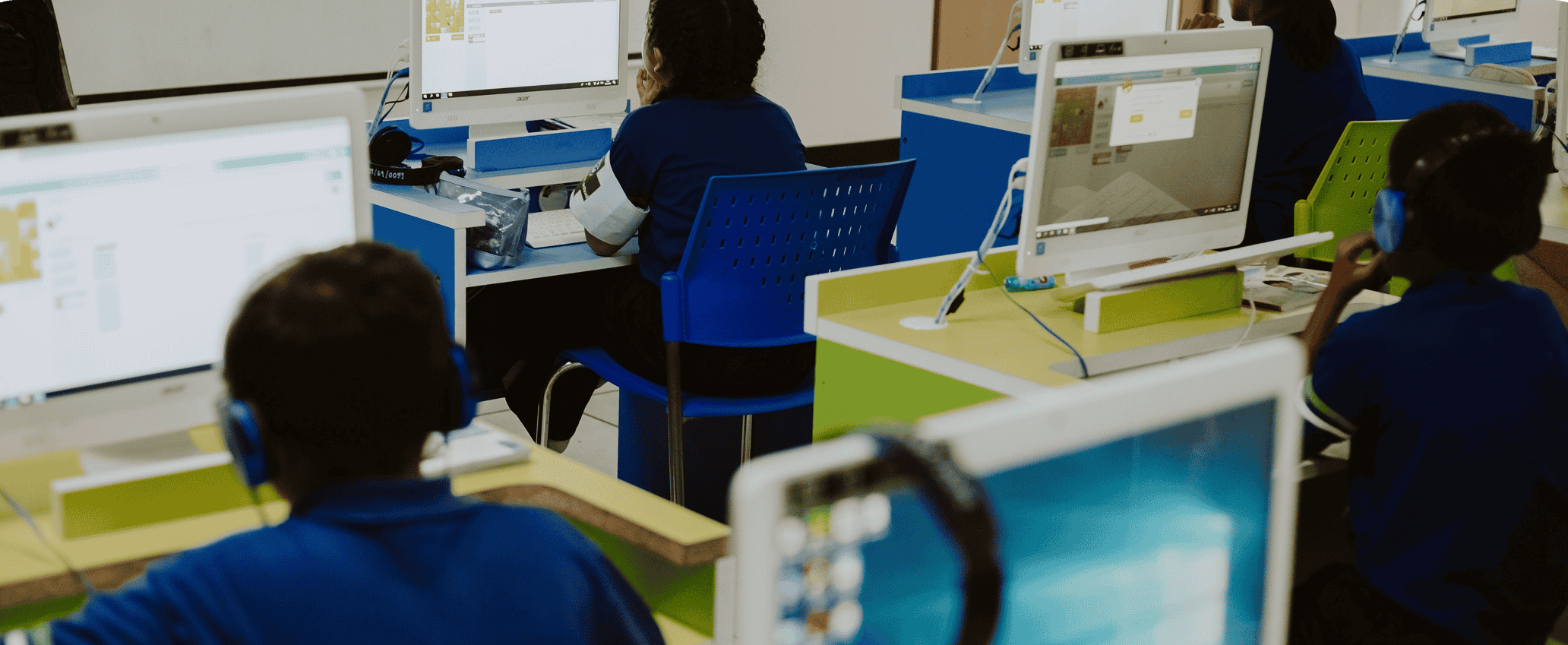 Students learning with desktop computers in a digital classroom