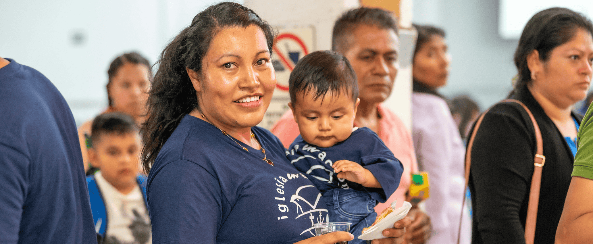 Mother holding her child at a community empowerment event