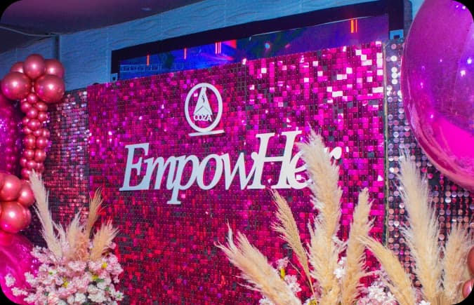 EmpowHer event backdrop with floral decorations