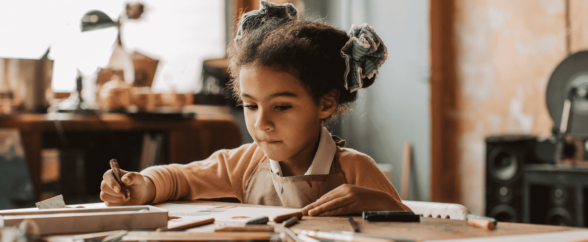 Young girl drawing at a table
