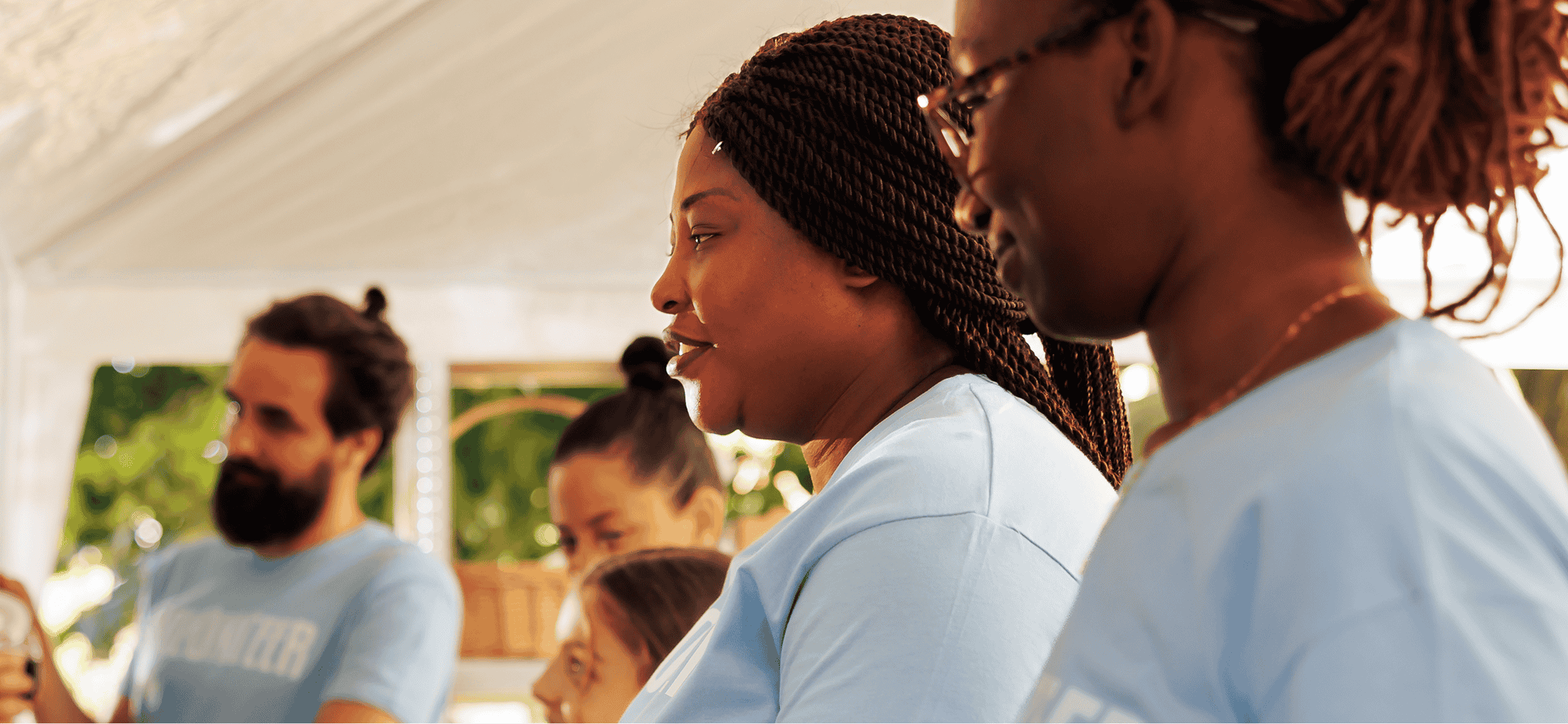 Volunteers serving at a community food bank outreach event